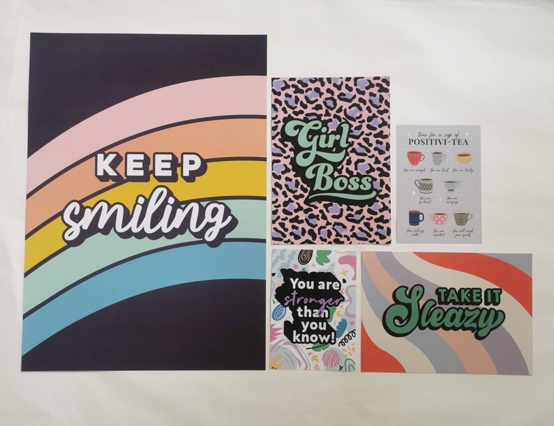 May include: Five colorful prints with motivational quotes. The prints feature a rainbow, a leopard print, a cup of tea, a colorful abstract design, and a rainbow with the words "Take It Sleazy".