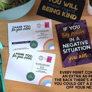 May include: Two thank you cards with a rainbow design and the text "Thank you for your order!" and "Here's a little treat". The cards also include a small green circle with the text "The Colour Print Studio".  A black card with the text "You will never regret being kind". A purple card with the text "If you stay positive in a negative situation you win."