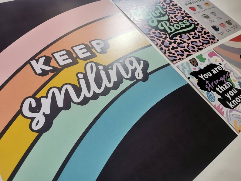 May include: A black background with a rainbow arc and the text "KEEP smiling" in white. The rainbow is made up of pink, orange, yellow, green, blue, and purple stripes.
