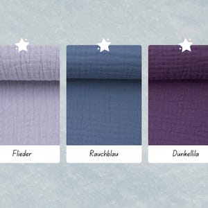 May include: Three fabric swatches in different colors: a light purple, a dark blue, and a dark purple. The swatches are labeled "Flieder", "Rauchblau", and "Dunkellila".