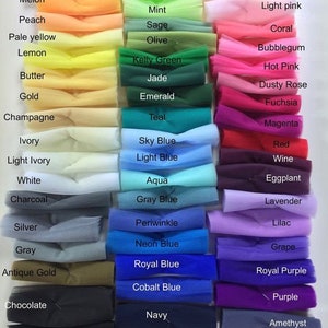 May include: A collection of tulle fabric swatches arranged in three columns, featuring a wide spectrum of colors including burnt orange, neon green, blush, charcoal, sky blue, and purple, each labeled with its corresponding color name.