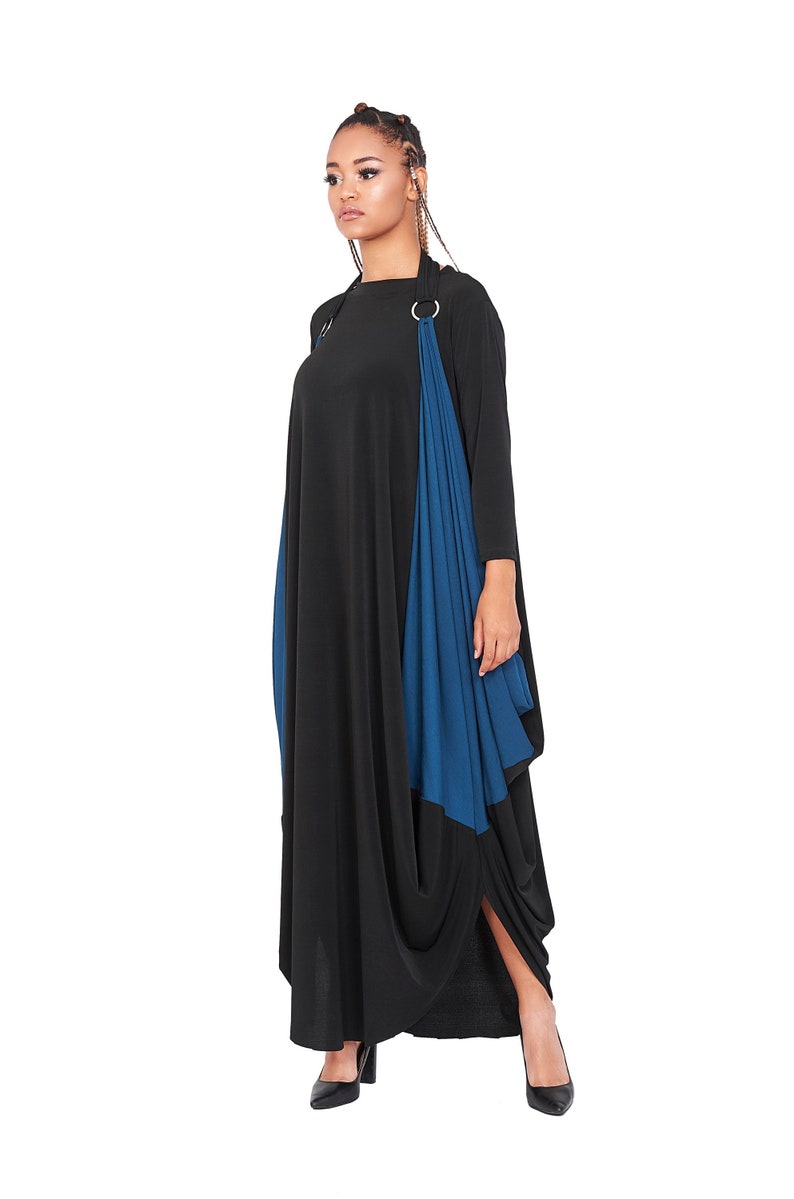 May include: A long black and blue dress with a draped design and a ring detail at the neckline.