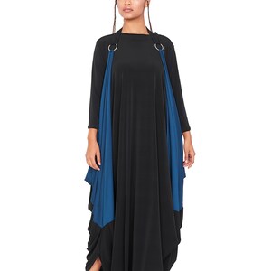 May include: A black maxi dress with a blue fabric overlay and silver rings at the shoulders. The dress has a loose, flowing fit and a gathered hem.