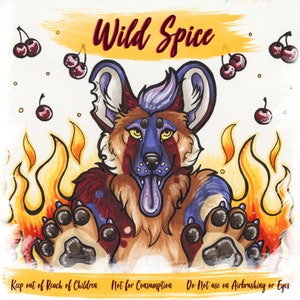 May include: A colorful illustration of a dog with a blue, red, and brown coat. The dog is surrounded by flames and cherries. The text "Wild Spice" is written in red at the top of the image. The text "Keep out of Reach of Children Not for Consumption Do Not use on Airbrushing or Eyes" is written at the bottom of the image.