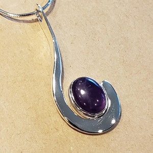 Amethyst gemstone cabochon set in a modern Sterling Silver Pendant with chain .