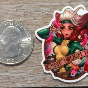 May include: A white sticker with a colorful illustration of a woman with red hair and green and yellow clothing. The woman is holding playing cards and the sticker says "Can't Touch This".
