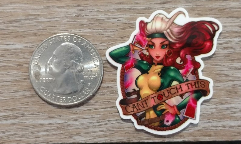 May include: A white sticker with a colorful illustration of a woman with red hair and green and yellow clothing. The woman is holding playing cards and the sticker says "Can't Touch This".