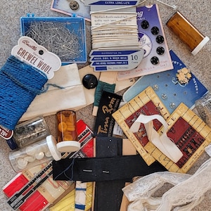 Vintage notions lot, snaps, hooks & eyes, white buttons, crewel wool, pins, sewing gauge, bias tape, leather button, pins, elastic cord