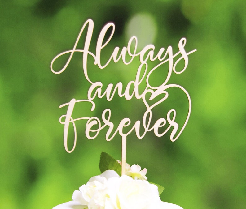 May include: Wooden cake topper with the words "Always and Forever" in a cursive font. A small heart is included in the design.