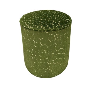 May include: A green velvet ottoman with a white and green patterned design.