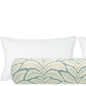 May include: A set of two white pillowcases and a decorative bolster pillow with a blue and white leaf pattern.