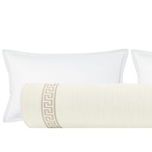 May include: A cream-colored bolster pillow with a Greek key design in a neutral tone, flanked by two white rectangular pillows. The bolster pillow is cylindrical and features the decorative border on each end. The pillows are arranged on a white background.