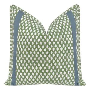 May include: Decorative throw pillow with a green and white geometric pattern. The pillow has a light blue border on each side. The pillow is square and appears to be made of a woven fabric.