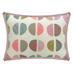 May include: Rectangular decorative pillow with a cream-colored background and a pattern of colorful half-circle shapes in shades of pink, green, gray, and orange. The pillow has a pink border.