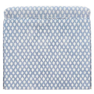 May include: A rectangular ottoman with a light blue and white patterned fabric. The pattern is a repeating design of stylized floral shapes. The ottoman has a padded top and a clean, tailored appearance.