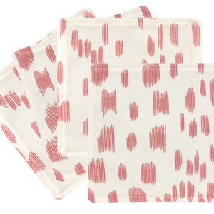 May include: Set of four pink and white cotton napkins with a geometric pattern.