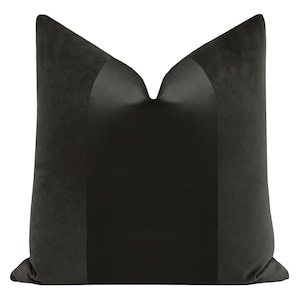 May include: A black velvet pillow with a satin center panel. The pillow is square and has a simple design.