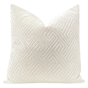 May include: White decorative pillow with an embossed geometric pattern.