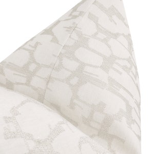 May include: White pillow with a subtle, embossed geometric pattern in a light gray color.