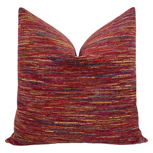 May include: A red, orange, yellow, and blue striped throw pillow with a soft, textured fabric.