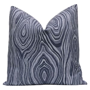 May include: Decorative throw pillow with a blue and gray wood grain pattern. The pillow has a soft, textured appearance and a neutral color palette, suitable for various interior design styles. The pillow is a square shape.