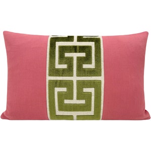 May include: A pink pillow with a green and white geometric pattern.