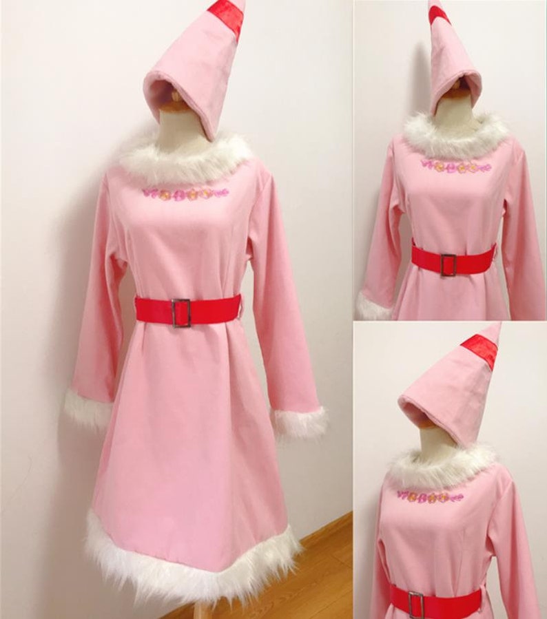 May include: Pink dress with a white fur trim and a red belt. The dress has a matching pink hat with a red ribbon.