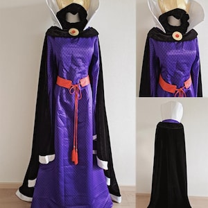 May include: A purple costume with a gold crown, black cape, and orange belt. The long dress has a high collar and a red jewel. The black cape has white trim. The costume is displayed on a mannequin.