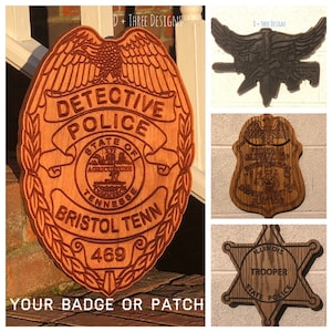 May include: Four wooden police badges with different designs. The first badge is a brown detective police badge with the text "DETECTIVE POLICE" and "BRISTOL TENN 469". The second badge is a brown eagle with wings spread. The third badge is a brown shield with the text "FEDERAL BUREAU OF INVESTIGATION DEPARTMENT OF JUSTICE". The fourth badge is a brown six-pointed star with the text "ILLINOIS TROOPER STATE POLICE".