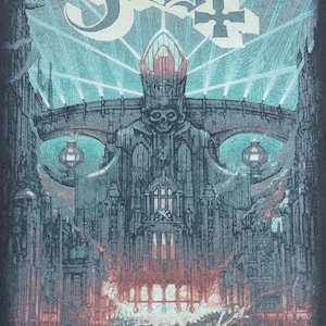 May include: A dark graphic featuring the band name "Ghost" in a stylized font above a detailed illustration. The illustration depicts a skeletal figure in a crown, set against a gothic cityscape with a bridge and glowing lights. The bottom of the image has text.