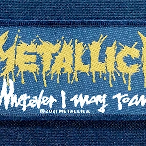 May include: A rectangular patch with the word "METALLICA" in yellow, dripping font. Below, the text "Whatever I may roam" is in white script. The patch is on a blue background, with the copyright notice "©2021 METALLICA".