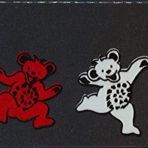 May include: Four stylized bear figures arranged in a row against a black background. The first bear is green, the second is red, the third is white, and the fourth is blue. Each bear features a distinct pose, with the blue bear standing on its head.