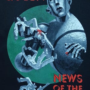 May include: Black graphic tee featuring the album art for Queen's "News of the World." The design includes a large robot, falling figures, and the band's name in red. The words "NEWS OF THE WORLD" are also in red.