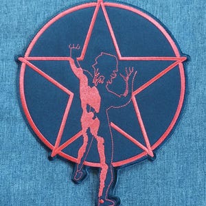 May include: Red embroidered patch with a black background featuring a five-pointed star and a silhouette of a person in a star pose.