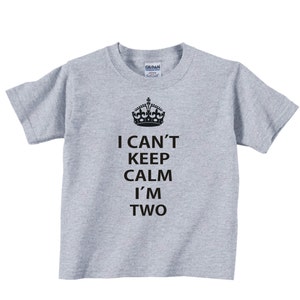 May include: Gray short-sleeved t-shirt with a black crown and the text "I can't keep calm I'm two".