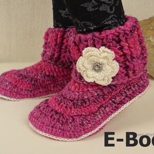 May include: Pink crocheted slipper boots with a white crocheted flower embellishment. The boots have a white trim around the edge. E-Book.