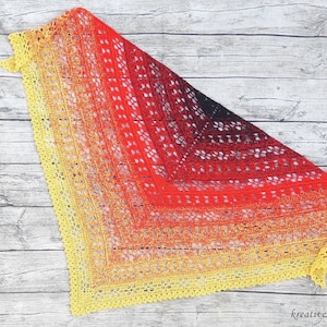 May include: A crocheted shawl with a gradient of yellow, orange, red, and black. The shawl has a delicate lace pattern and a scalloped edge.