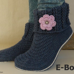 May include: Blue crocheted slipper boots with a white trim and a pink flower embellishment. E-Book.
