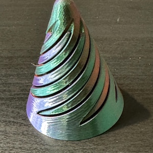 May include: A 3D printed iridescent green and purple cone with a spiral design.