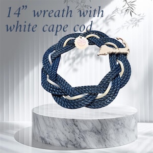 May include: A 14 inch blue and white rope wreath with a wooden Cape Cod cutout.