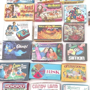 May include: A collection of seventeen miniature board game boxes including titles such as Bewitched, Mall Madness, Let's Go Fishin', Art-a-matic, Voice of the Mummy, Dungeons & Dragons, Ghosts!, Dream Phone, Simon, Casper, Risk, Operation, Monopoly, Candy Land, and Mystery Date.