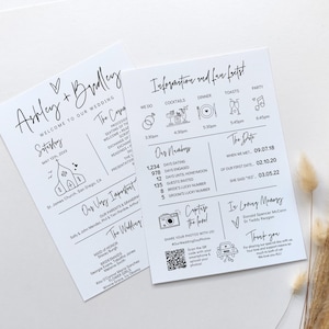 May include: Two white wedding programs with black text and illustrations. One program lists the wedding party and venue. The other program includes the wedding timeline, date, and fun facts. Dried ornamental grass is in the background.