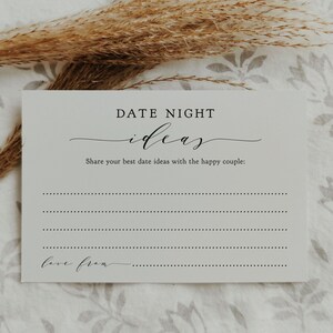 May include: A white card with the text "DATE NIGHT ideas" in a stylish font. Below, it reads "Share your best date ideas with the happy couple:" followed by dotted lines for writing. The bottom of the card says "love from."