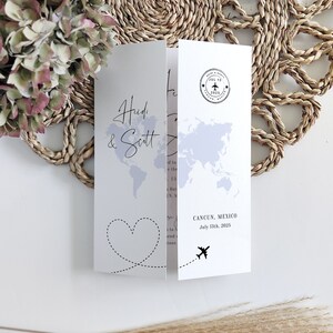 May include: A wedding invitation with a world map background and a heart with a dotted line. The text reads "Heidi & Scott" and "CANCUN, MEXICO July 13th, 2025".