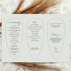 May include: A wedding ceremony program with a light gray background and a floral design. The program lists the ceremony order, gospel reading, and thank you message. The names Chloe & John are at the bottom.