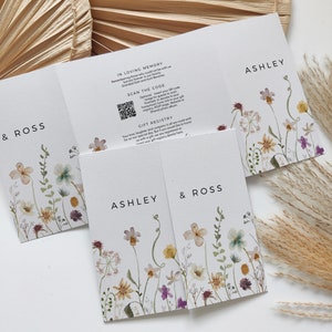 May include: A wedding invitation with a floral design. The invitation is folded in thirds and features the names Ashley and Ross. The invitation also includes a QR code and the text "Scan the code" and "Gift Registry".