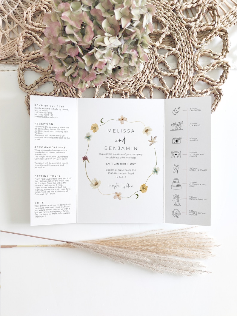 May include: A tri-fold wedding invitation with floral accents. The invitation features the names "Melissa and Benjamin" and event details. The design includes a timeline of events and RSVP information. The invitation is on a white background.