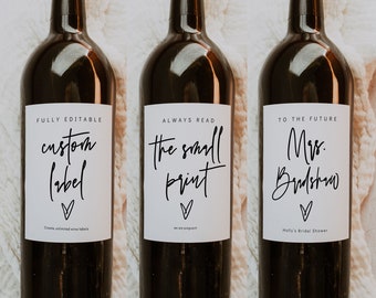 May include: Three wine bottles with white labels and black calligraphy text. The labels read "FULLY EDITABLE custom label", "ALWAYS READ the small print", and "TO THE FUTURE Mrs. Bradshaw".