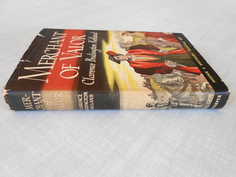 May include: A vintage hardcover book titled "Merchant of Valor" by Clarence Budington Kelland. The cover features a red and black design with an illustration of figures in period clothing. Published by Harper & Brothers.