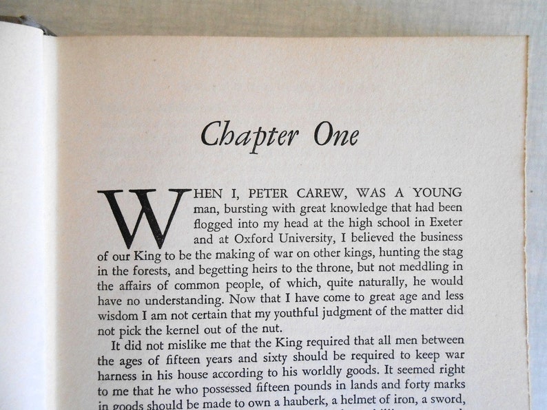 May include: Open book page with the title "Chapter One" in a serif font. The text begins with a large, ornate "W" and continues with paragraphs of printed text. The paper is aged, with a slightly yellowed tone.
